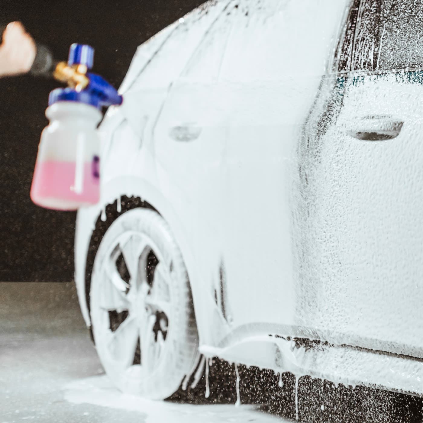 Car being washed with snow foam
