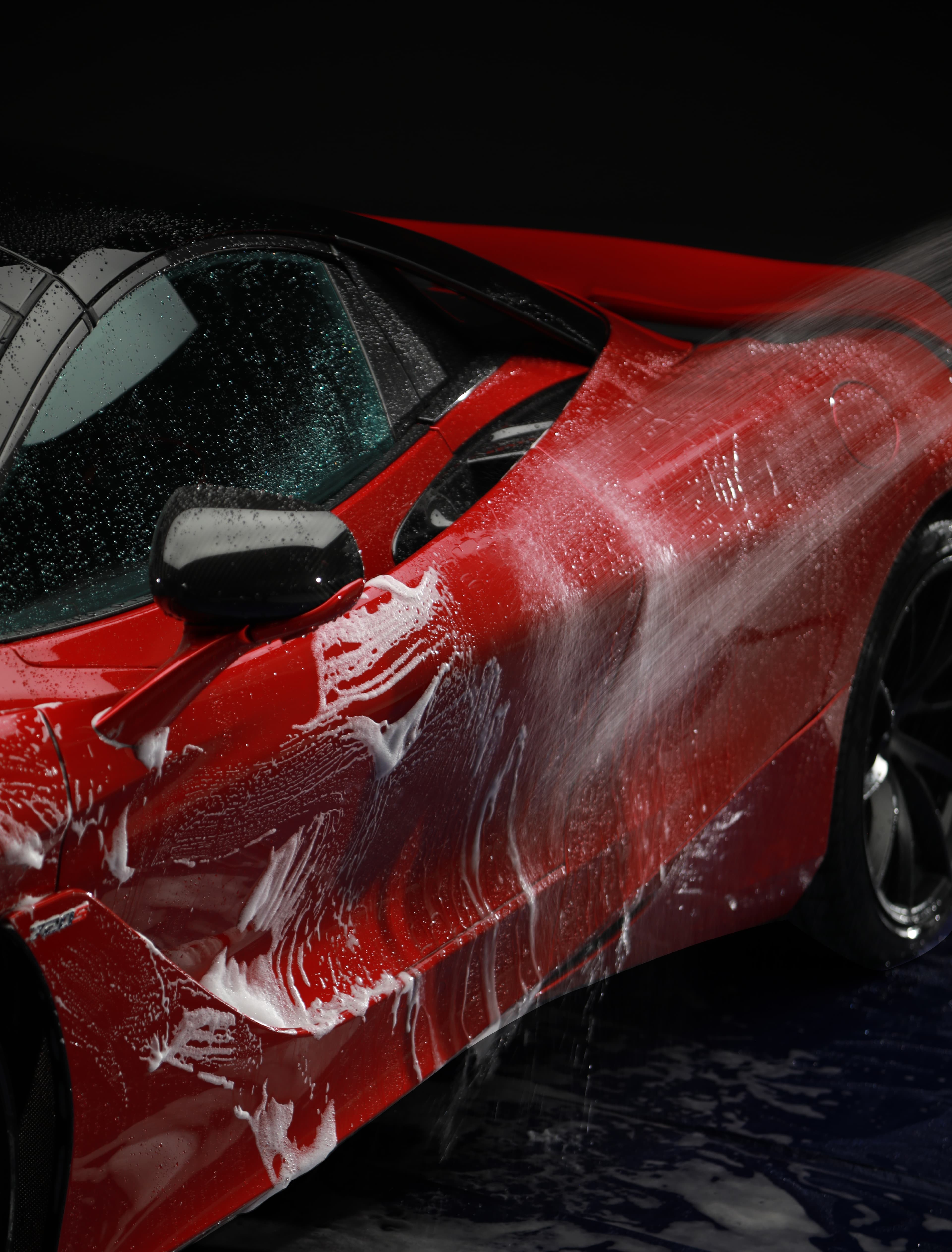 Hand washing car with shampoo