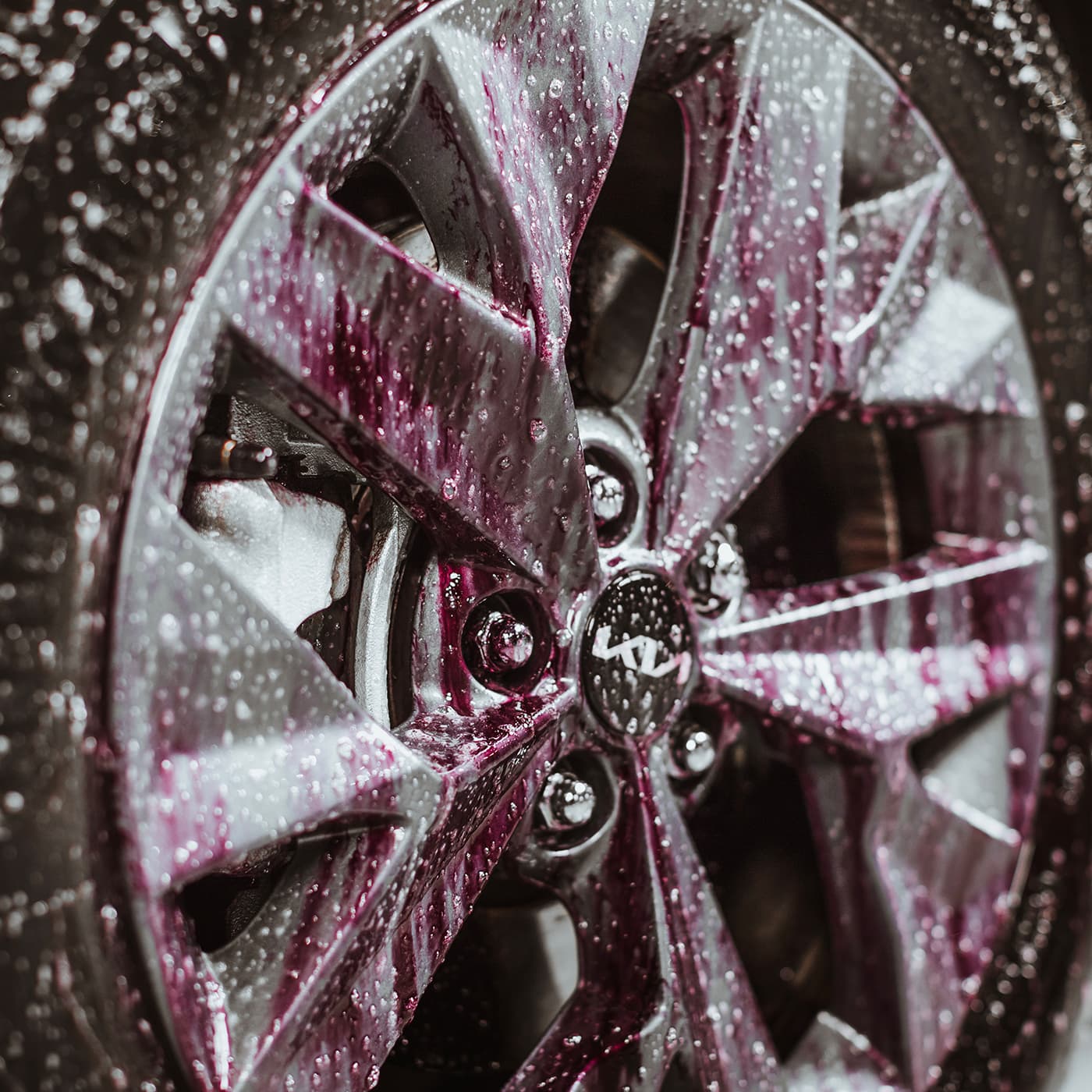 Car wheel and tyre being cleaned